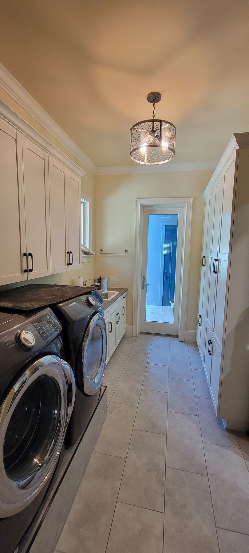 A laundry room with a washer and dryer in it.