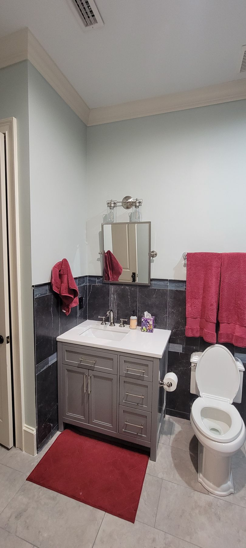 A bathroom with a sink , toilet , and mirror.