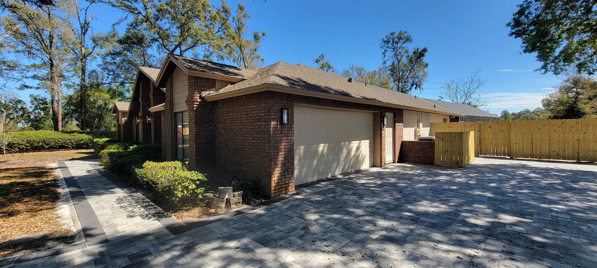 A house with a garage and a driveway in front of it.