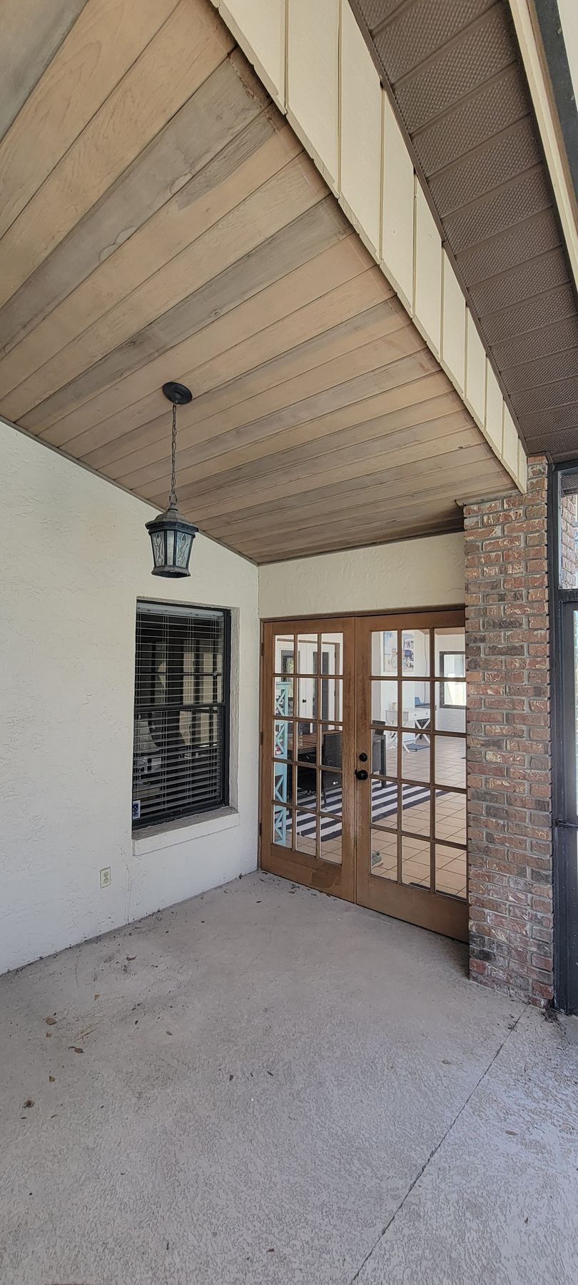 There is a ceiling fan hanging from the ceiling of the room.