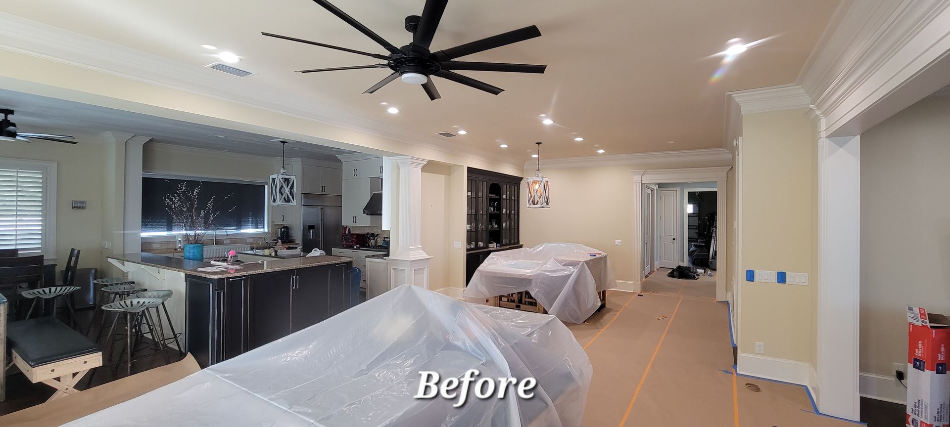 A before picture of a kitchen with a ceiling fan.