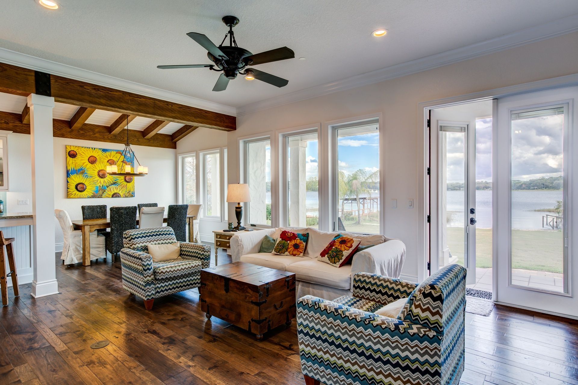 A living room filled with furniture and a ceiling fan.