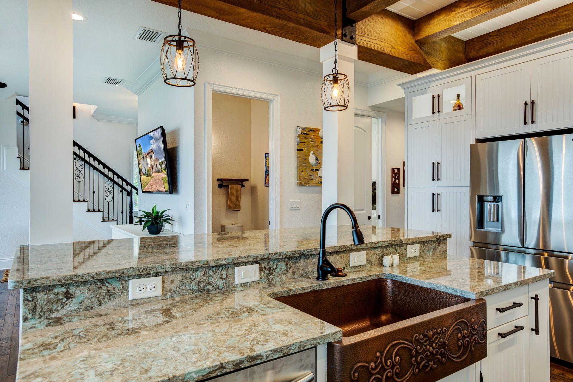 A kitchen with a copper sink and granite counter tops.