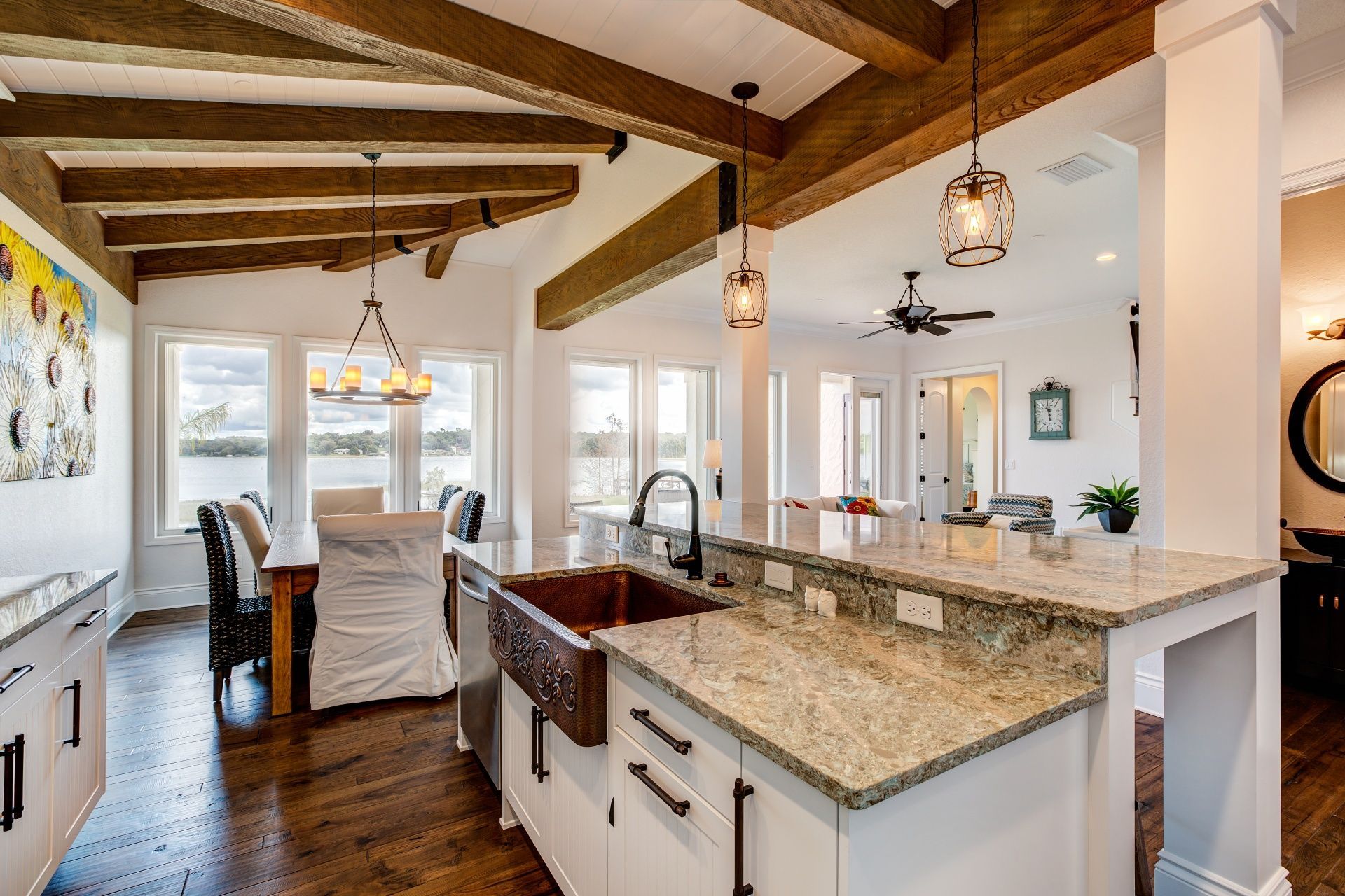 A kitchen with a copper sink and granite counter tops.
