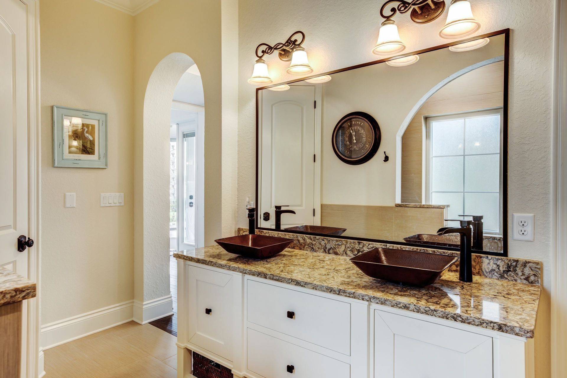 A bathroom with two sinks and a large mirror.