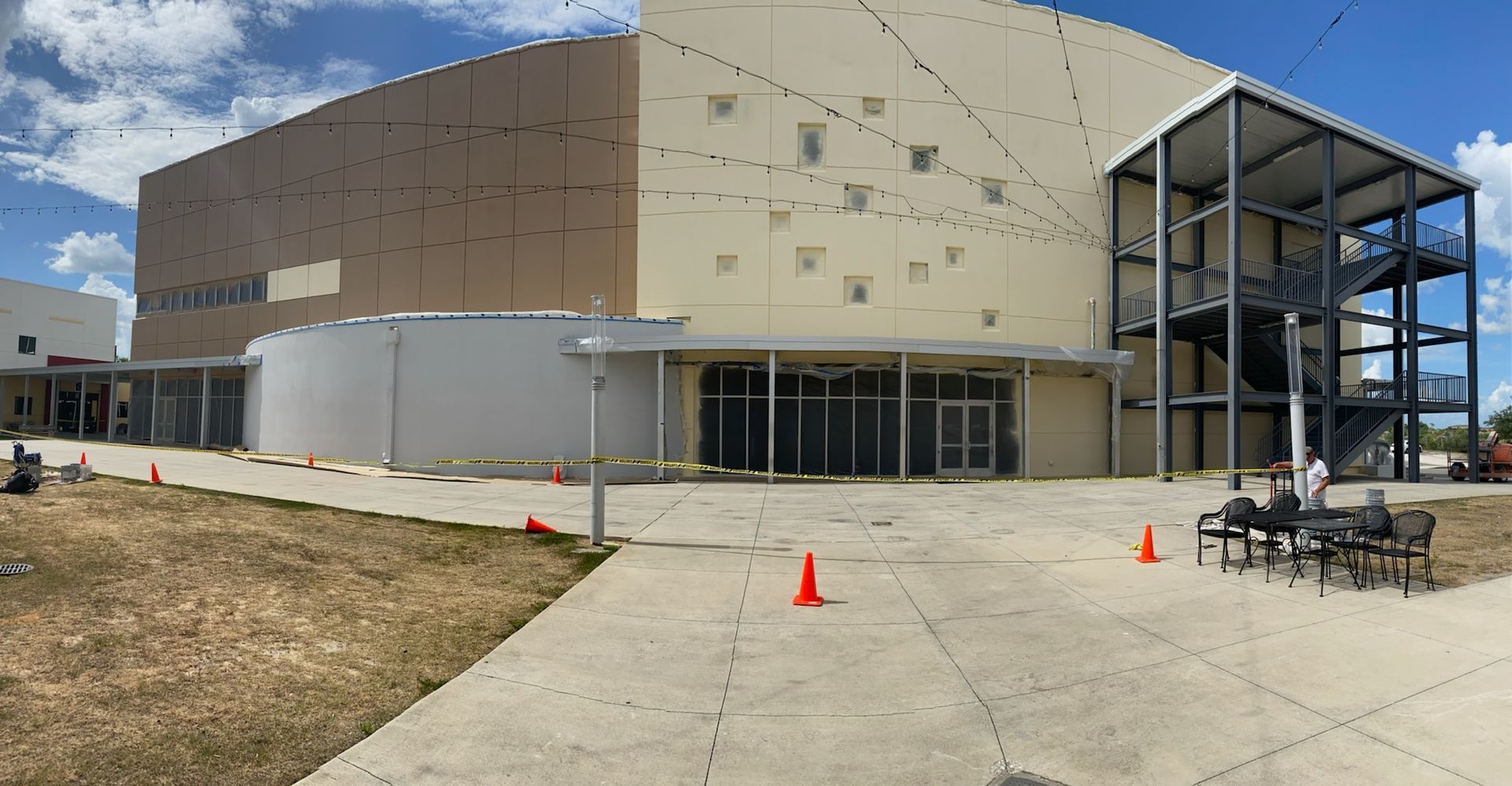 A large building with a lot of windows is under construction.