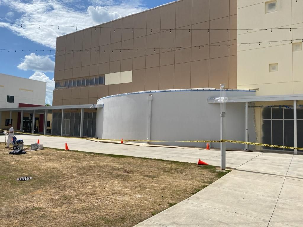 A large building with a lot of windows is being built.