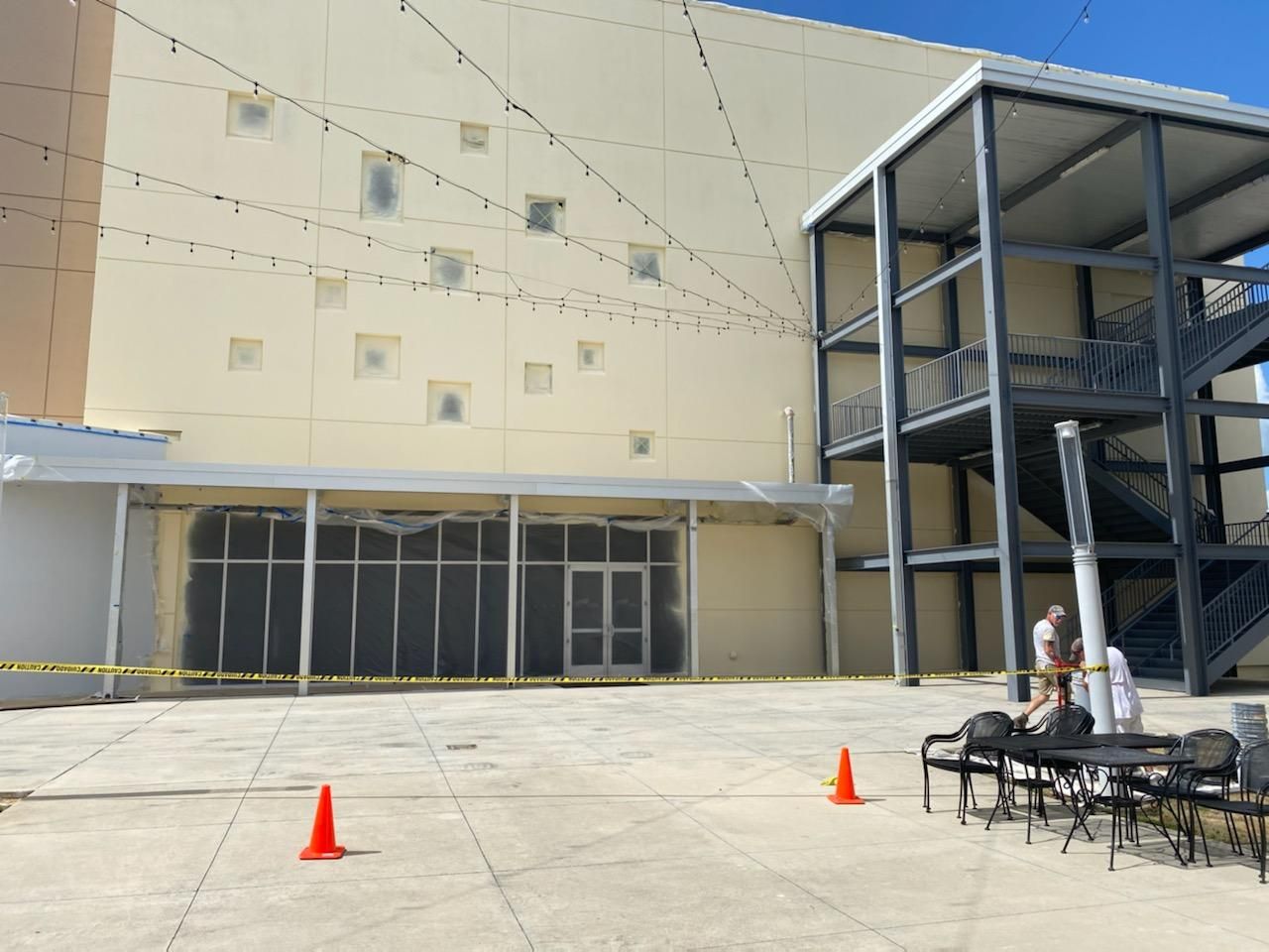 A large building with stairs and cones in front of it