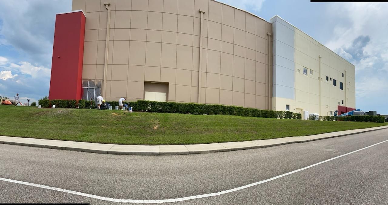A large building with a red and white stripe on the side