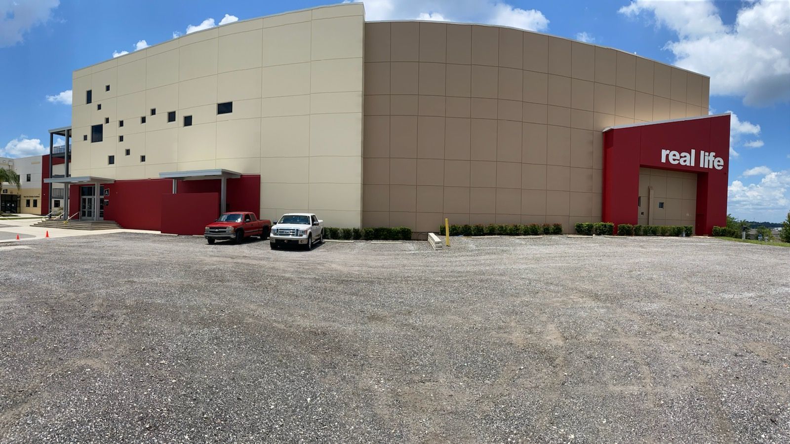 A large building with cars parked in front of it.