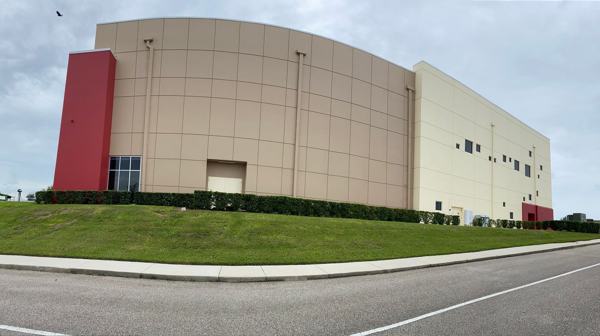 A large building with a red stripe on the side of it