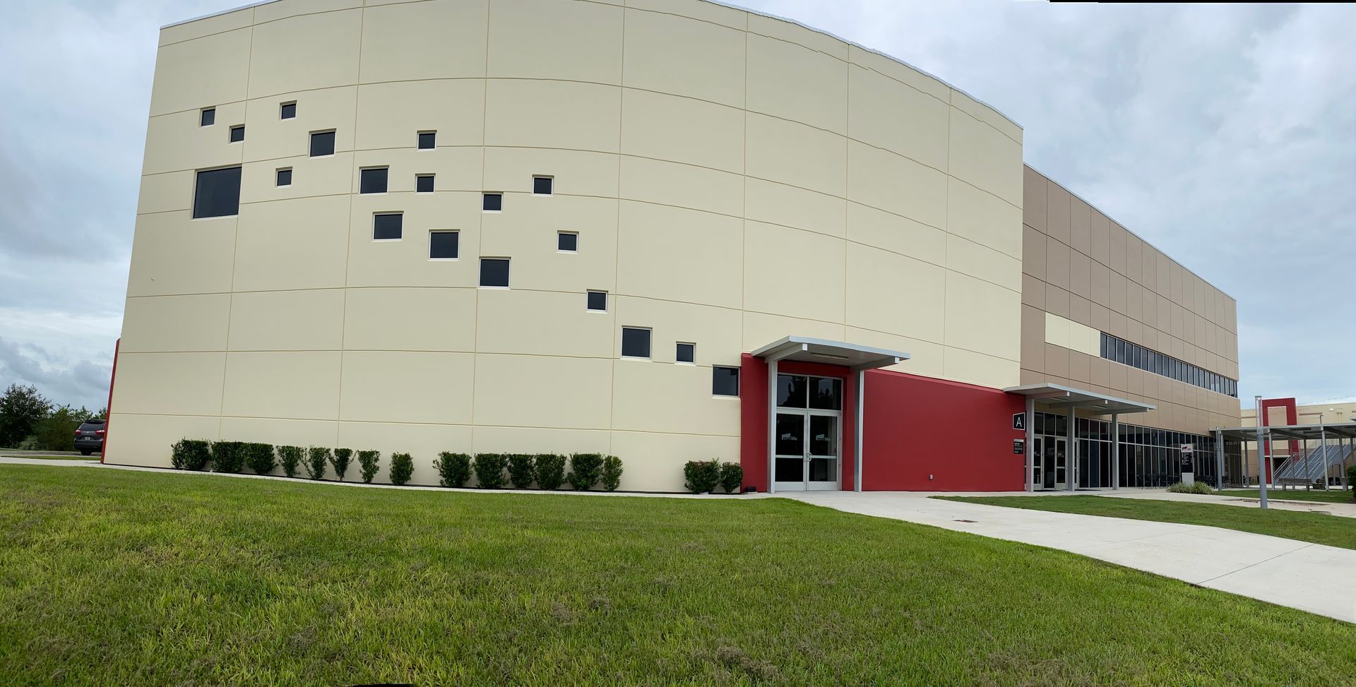 A large building with a red entrance and a lot of windows