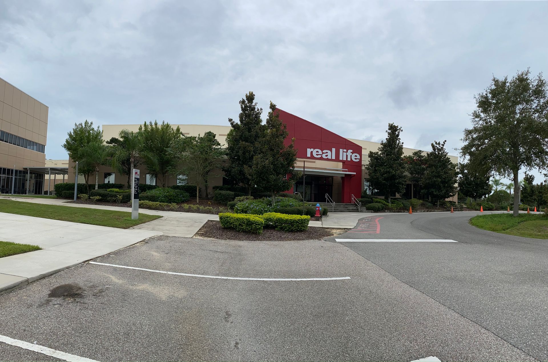 A red and white building with the word real life on it