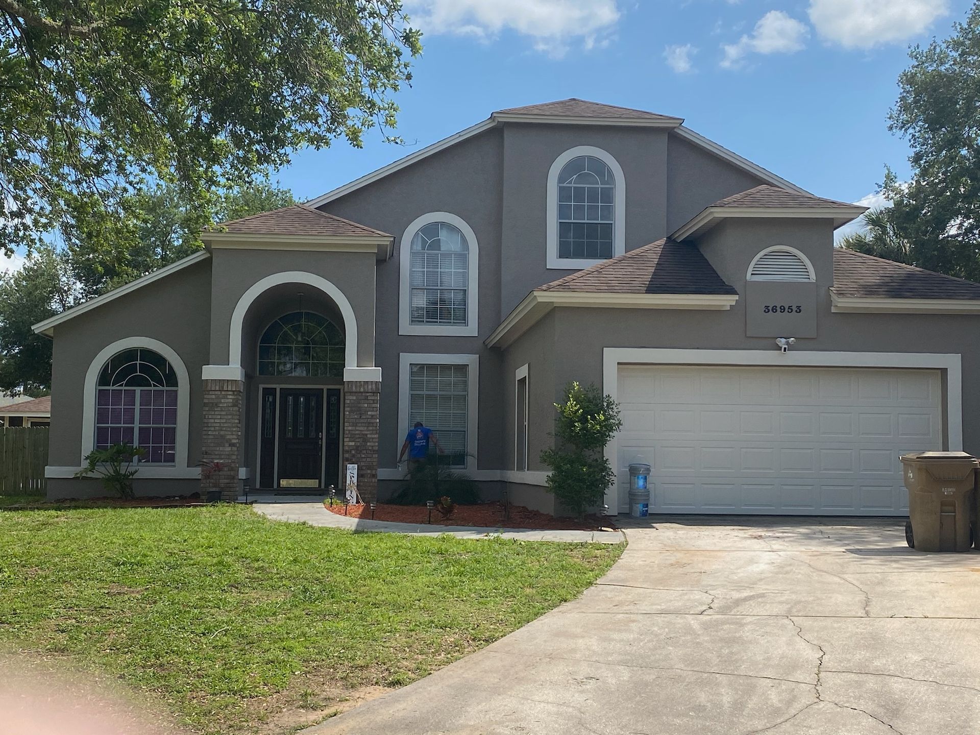 A large gray house with a white garage door