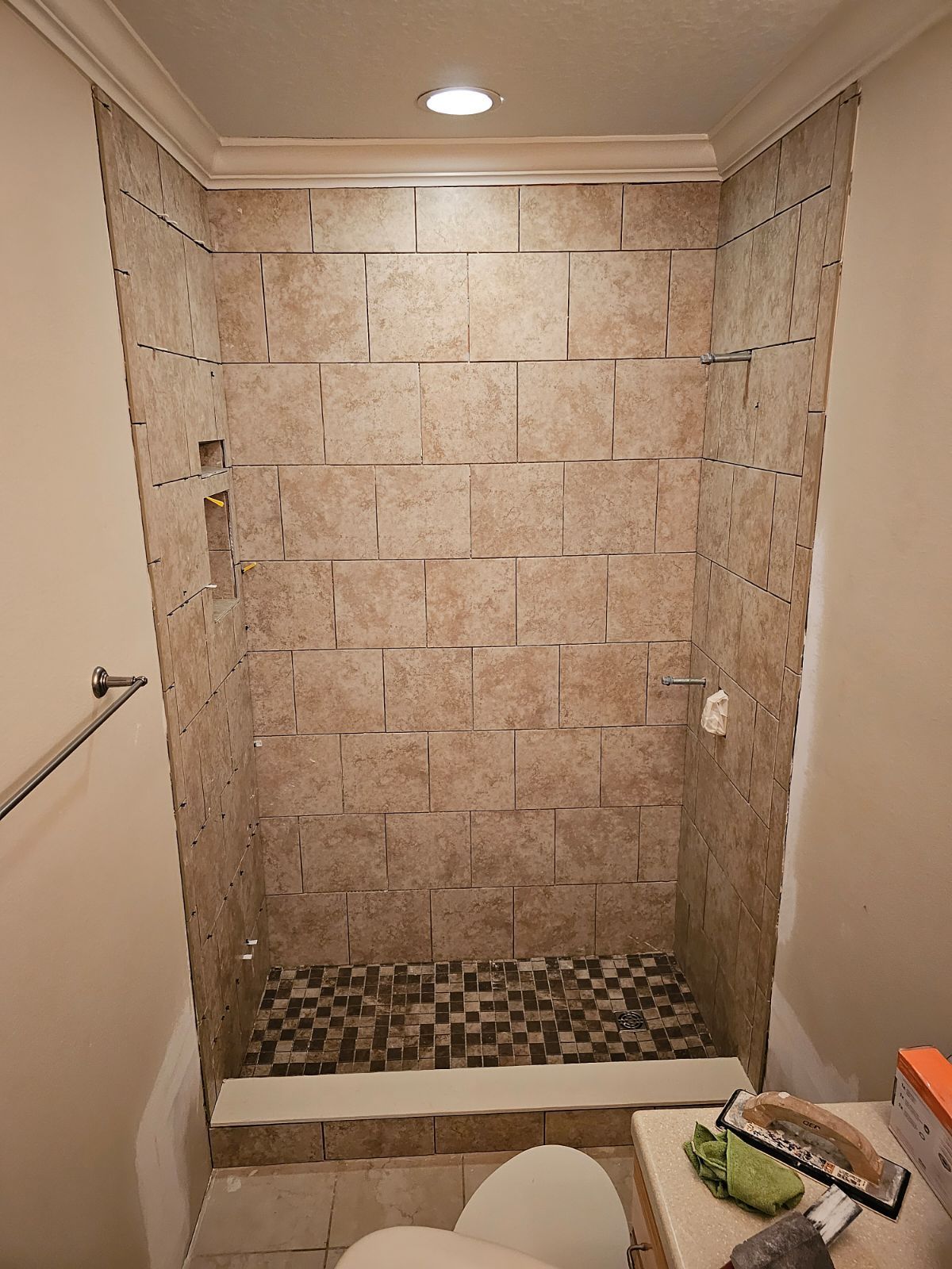 A bathroom with a walk in shower and a toilet.