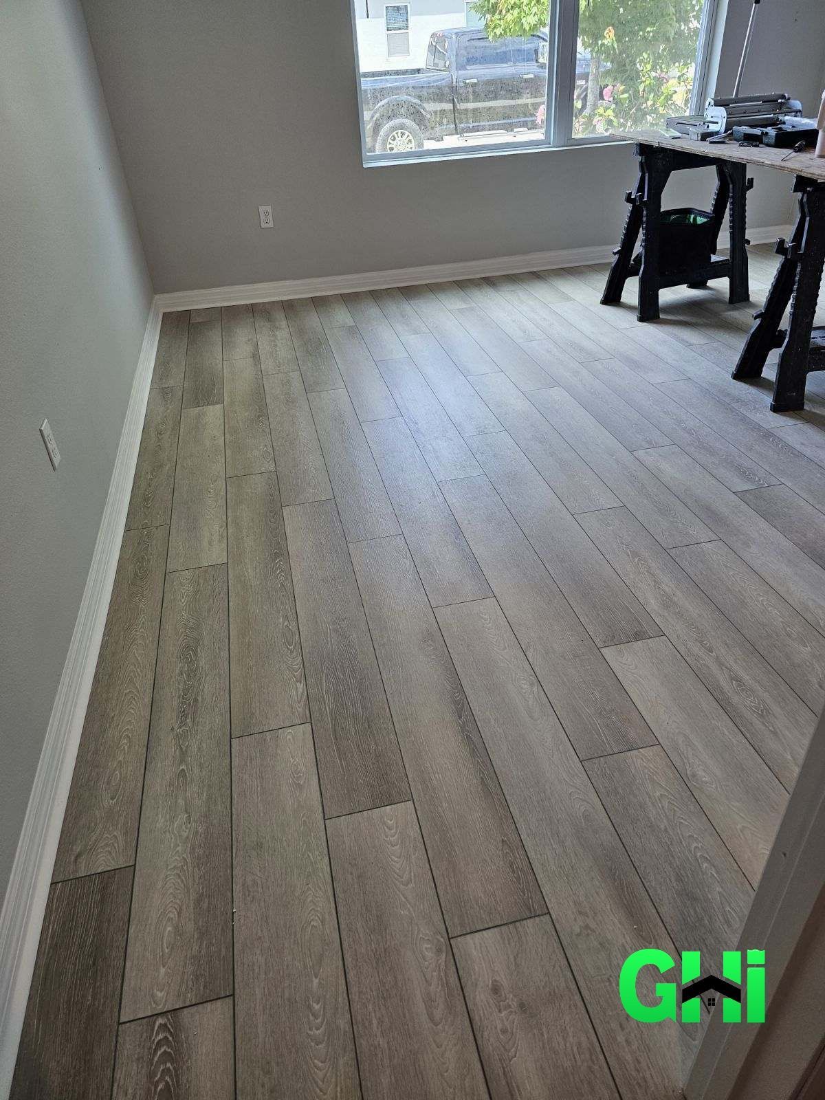 A room with a wooden floor and a window.