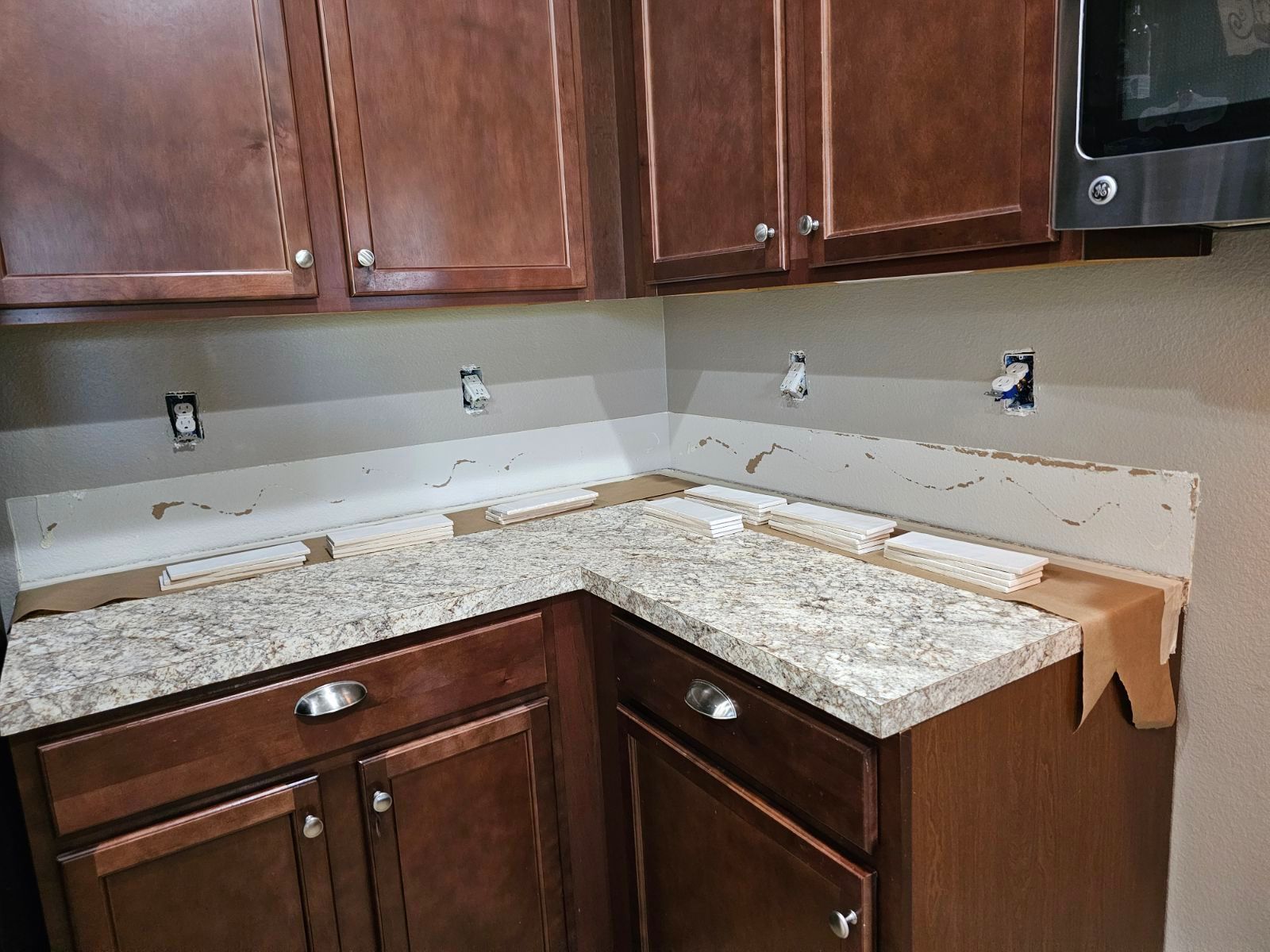 A kitchen with granite counter tops and wooden cabinets