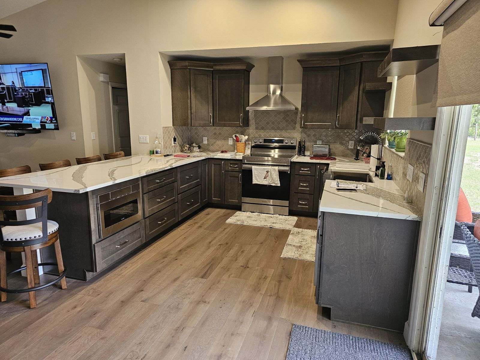 A kitchen with stainless steel appliances and a large island.