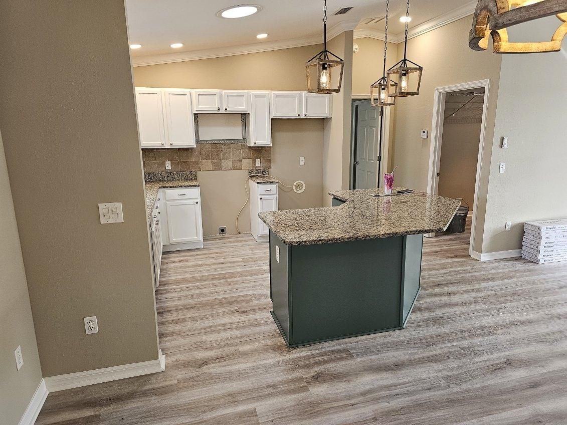 A kitchen with a large island in the middle of it.