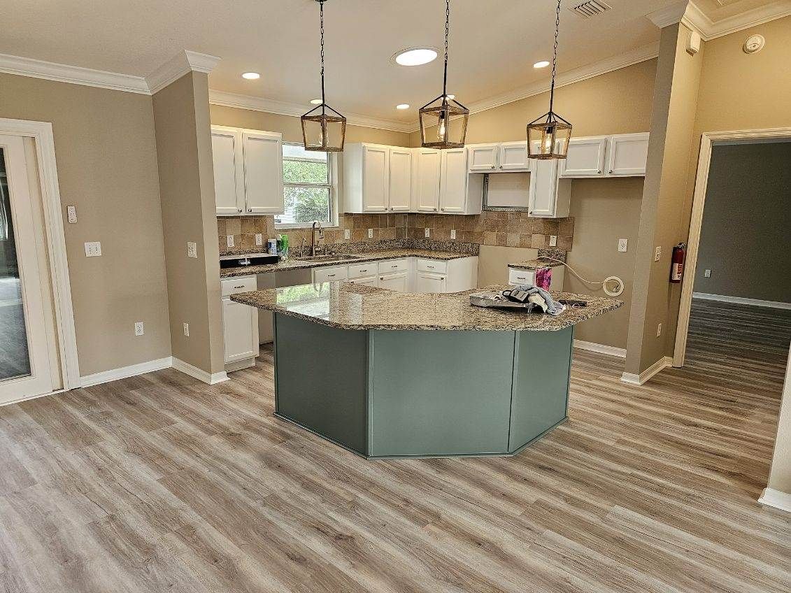 A kitchen with a large island in the middle of the room.