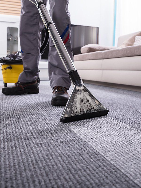 Man Cleaning Carpet Using Vacuum — Carpet Cleaning In Townsville QLD