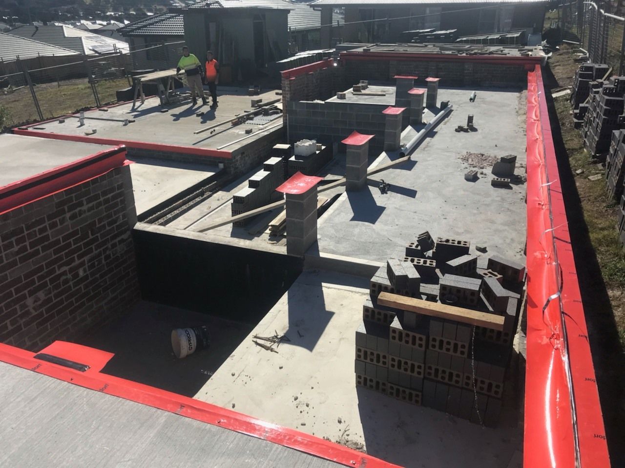 A construction site with two men walking across — Advanced Pest Control Wollongong in Albion Park Rail, NSW