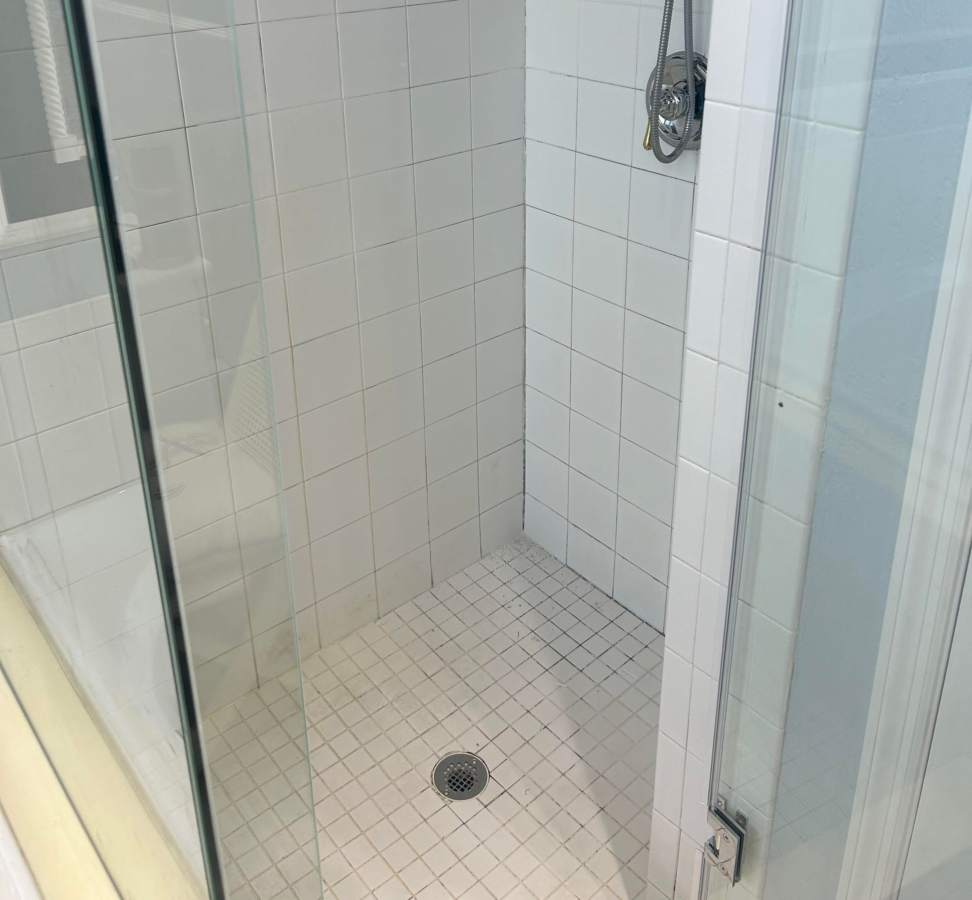 A bathroom with a shower stall and a toilet.