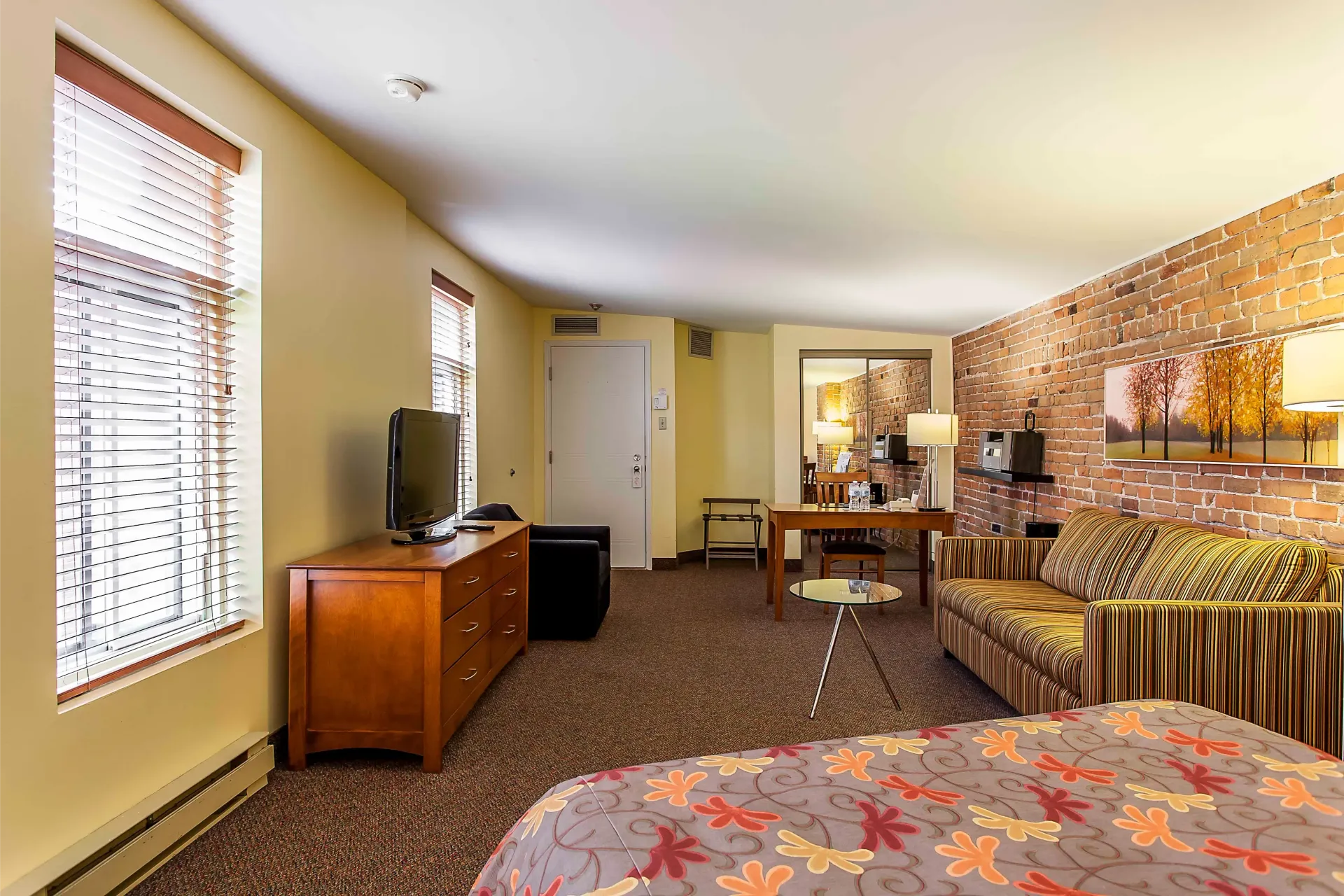 Une chambre d'hôtel avec un lit, un canapé et une télévision