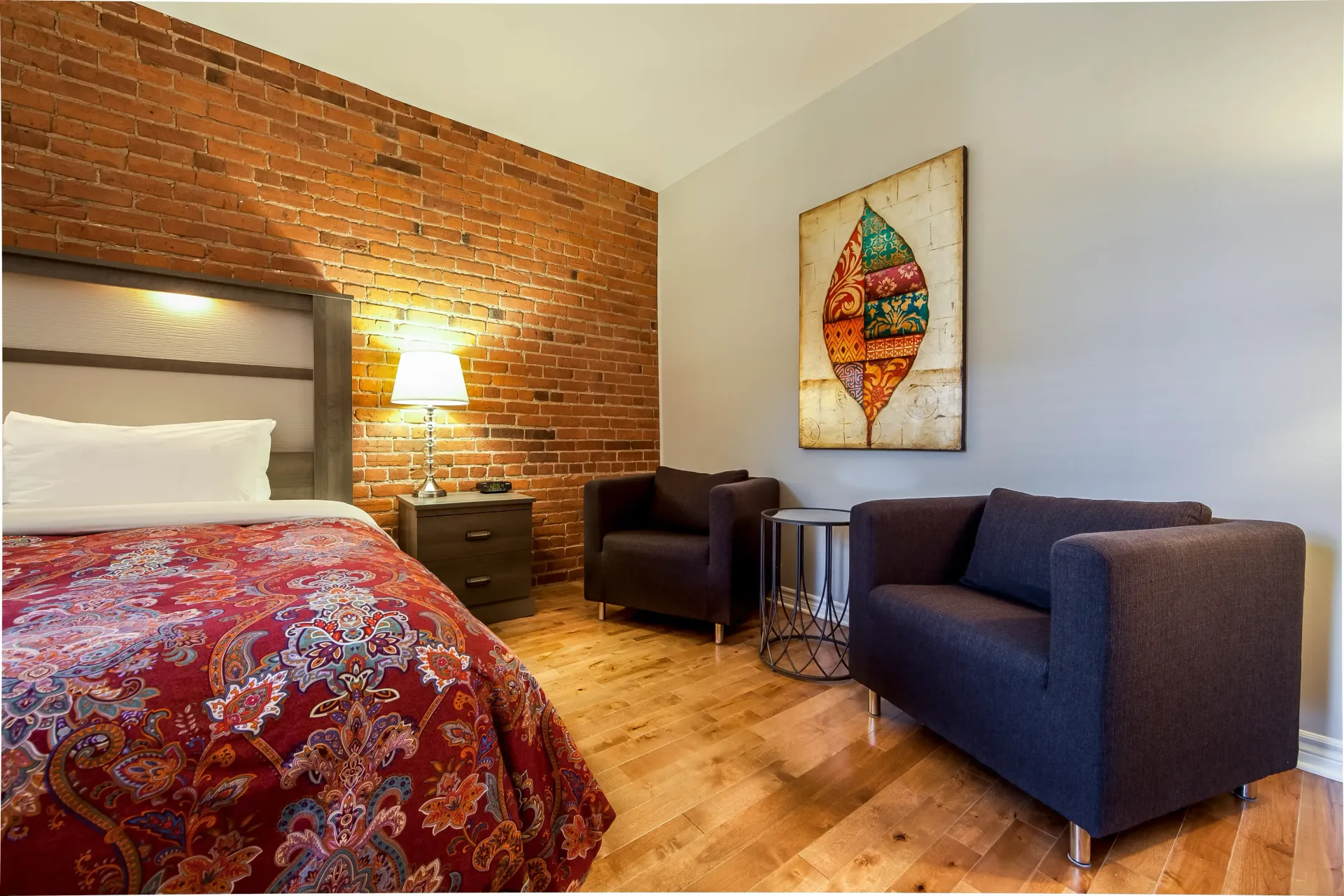 Une chambre d'hôtel avec un lit et deux chaises
