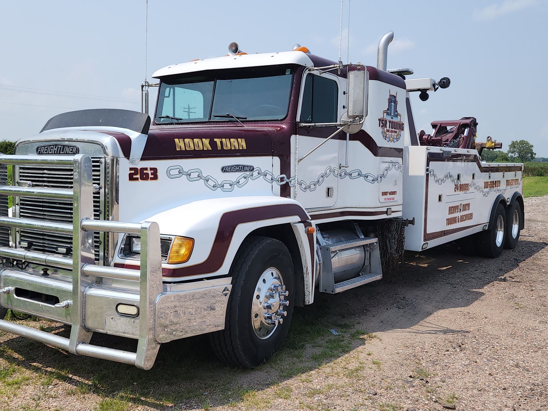 A tow truck is parked on the side of the road