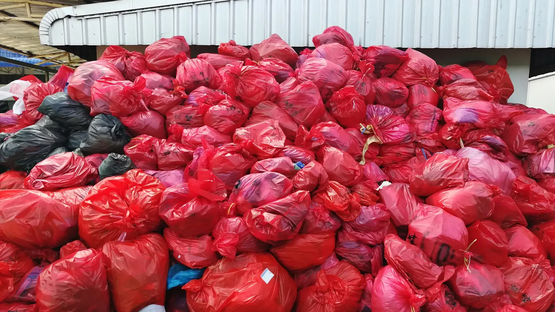 A pile of red plastic bags sitting on top of each other.