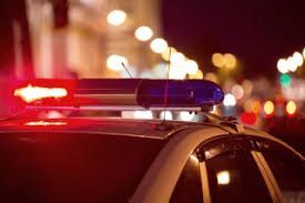 A police car with a red and blue light on top of it.