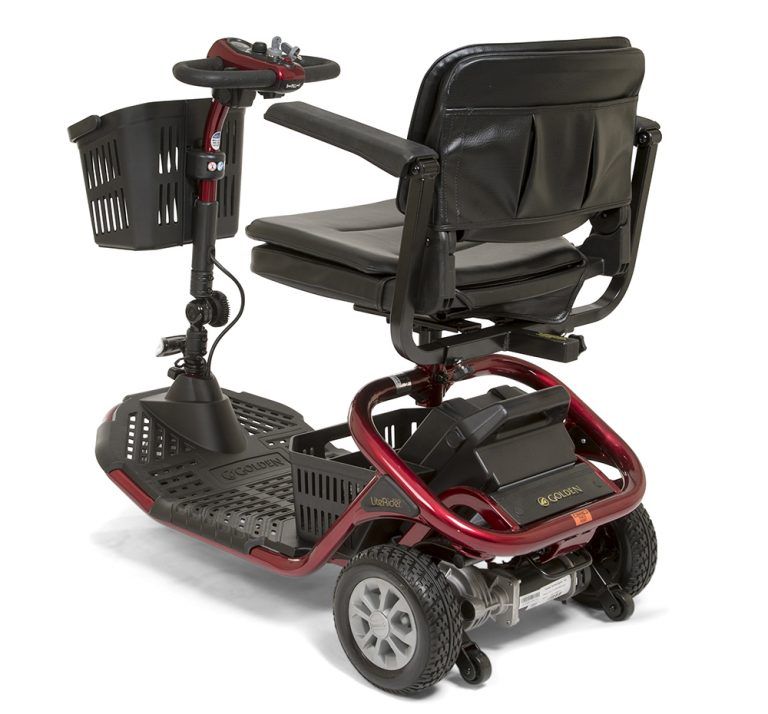 The back of a red and black mobility scooter with a basket