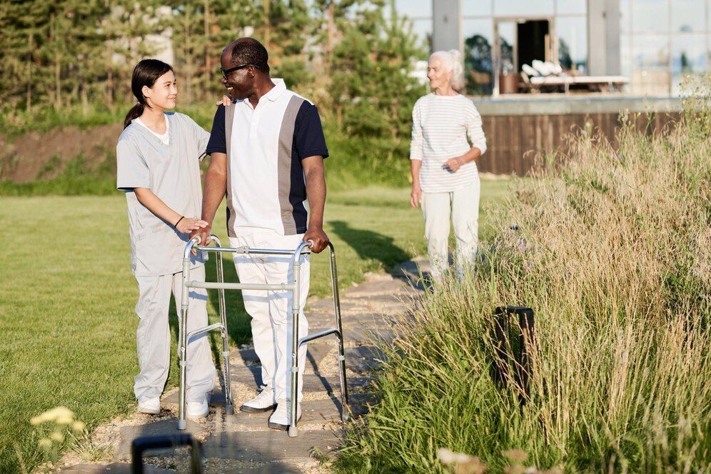 A man with a walker is being helped by a nurse.