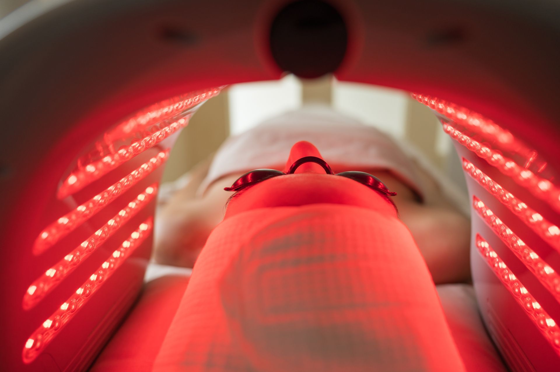 Woman resting under red light therapy seen from inside close-up concept