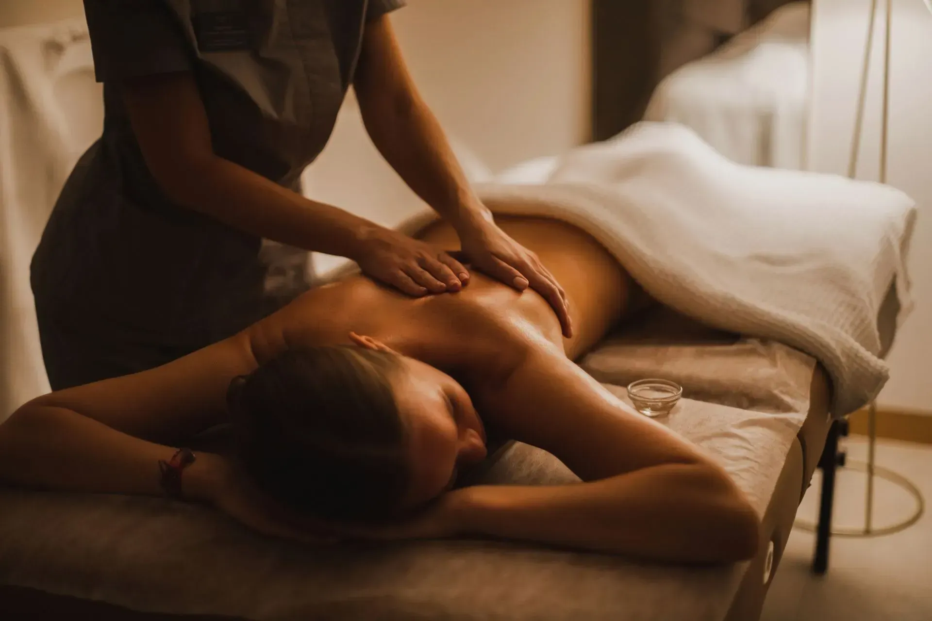 Person receiving a back massage at a spa.