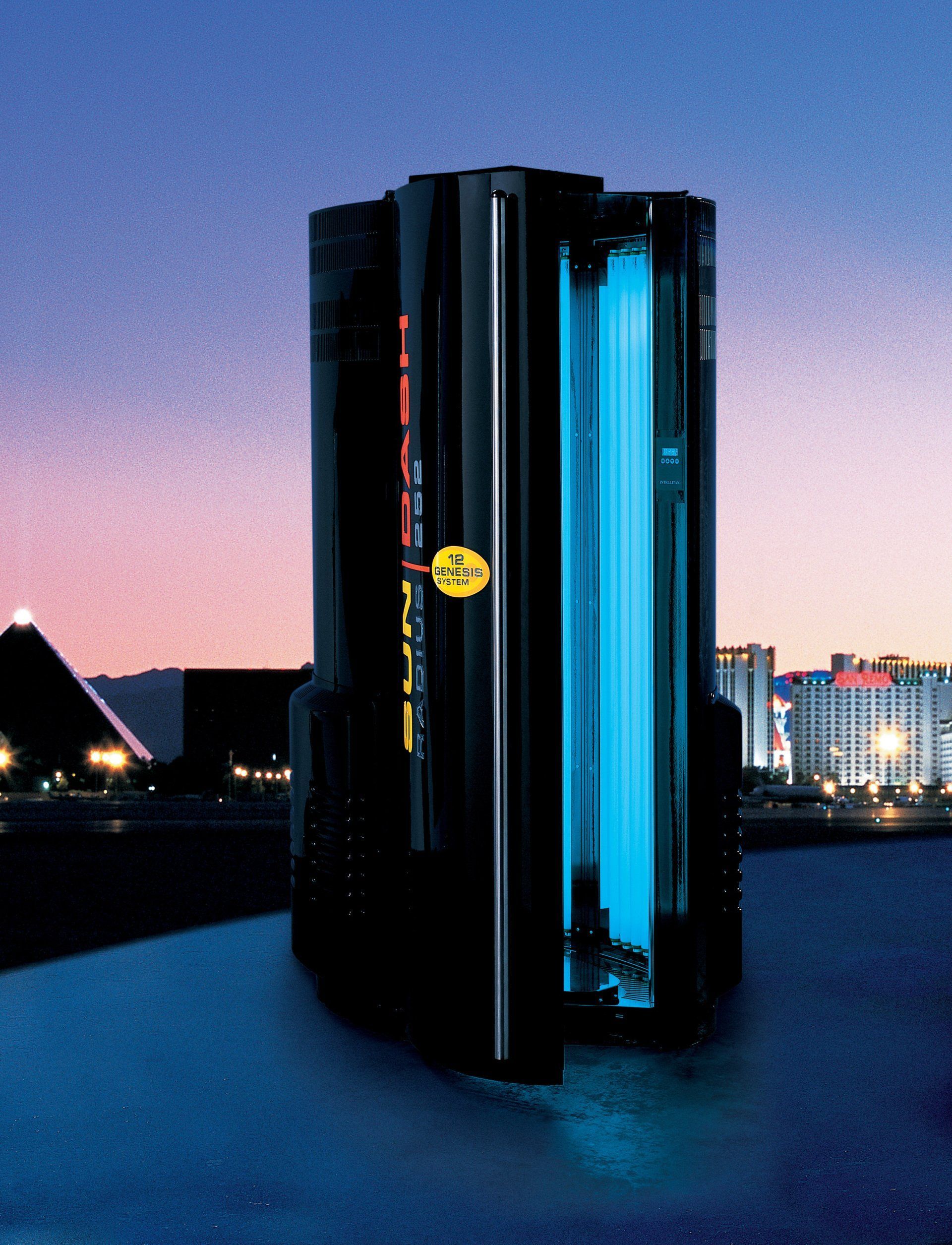 Black tanning booth with blue lights, outdoors, city background with pyramid, dusk.