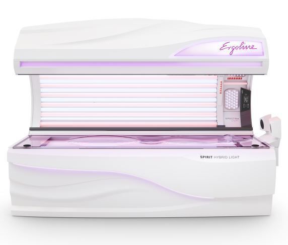 White Ergoline sunbed with pink lighting.