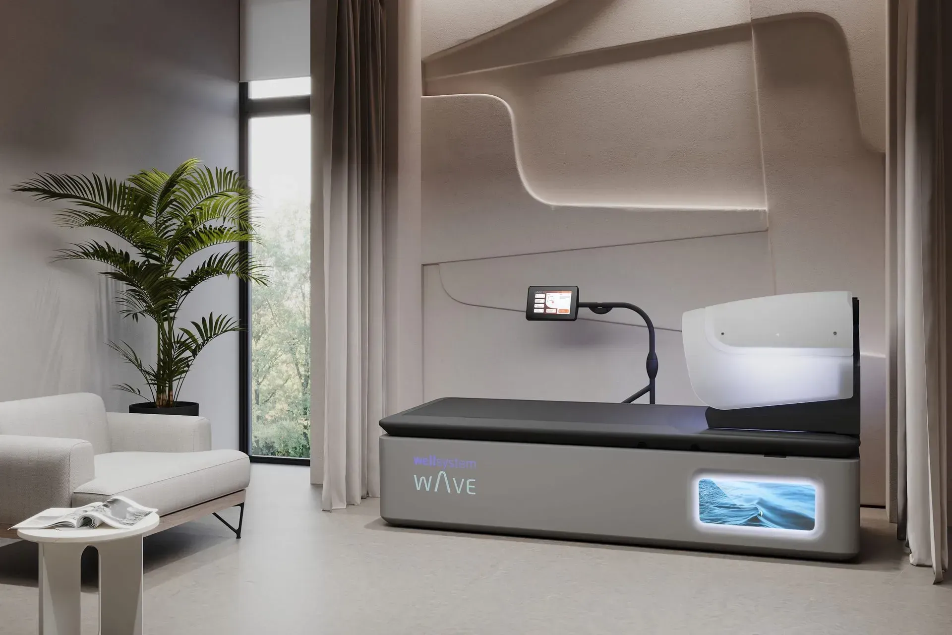 Modern medical bed in a bright room with a plant, chair, and a display screen.