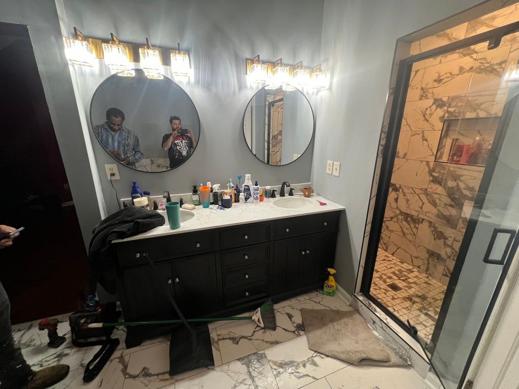 A bathroom with two sinks and two mirrors.