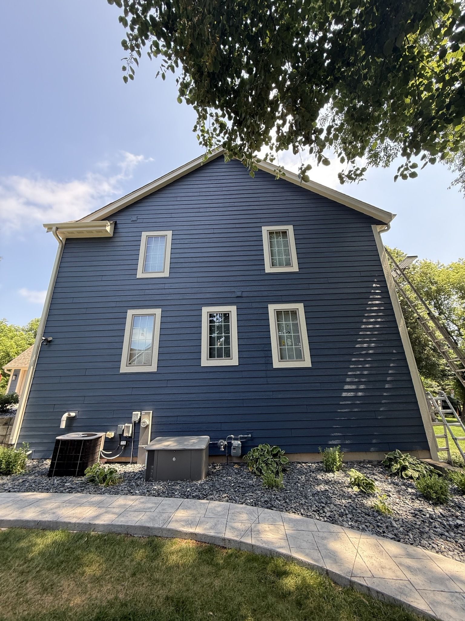 A blue house exterior features horizontal siding with a distorted, wavy visual effect around five rectangular windows.