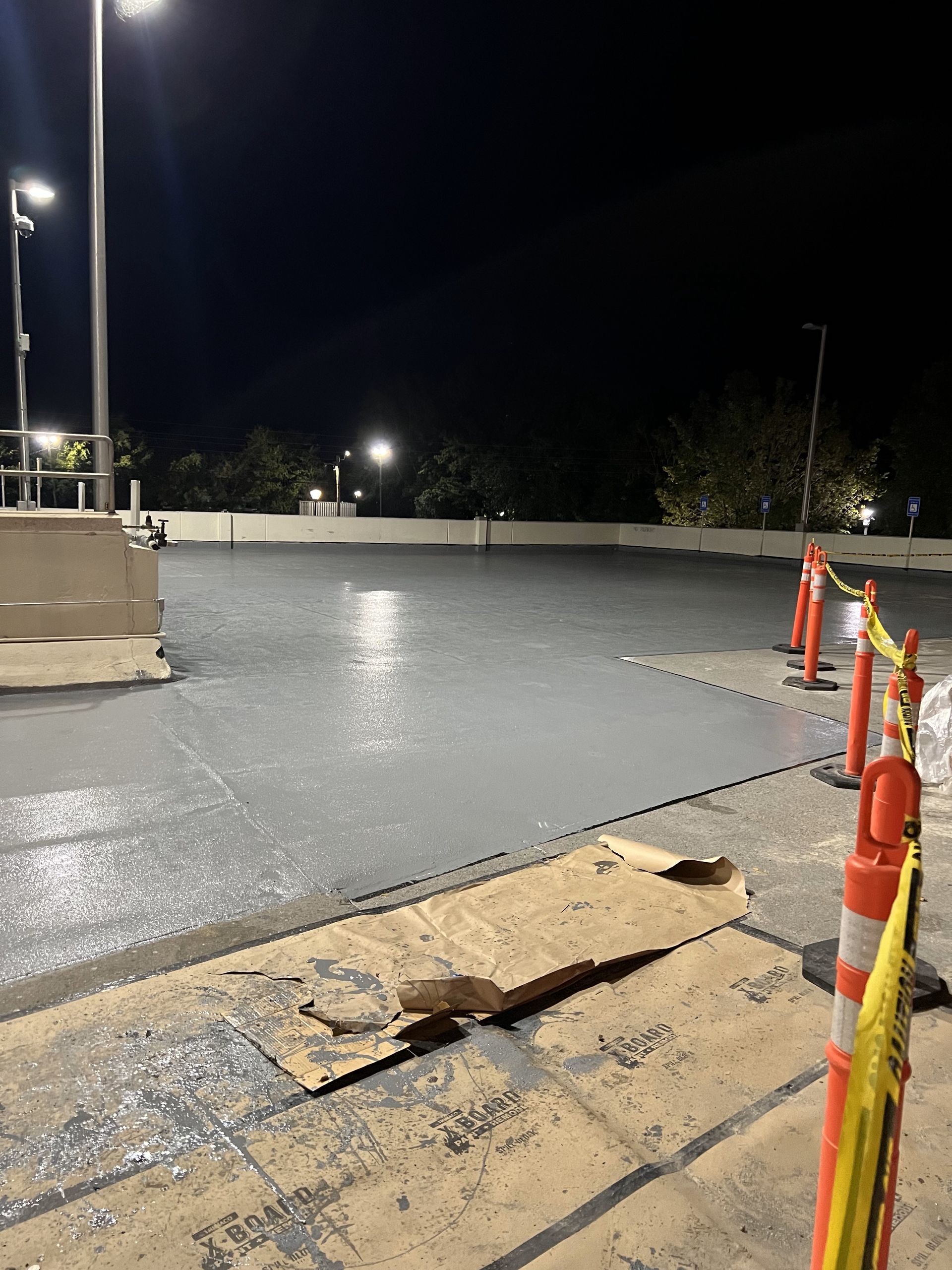 A parking lot with a lot of orange and white cones