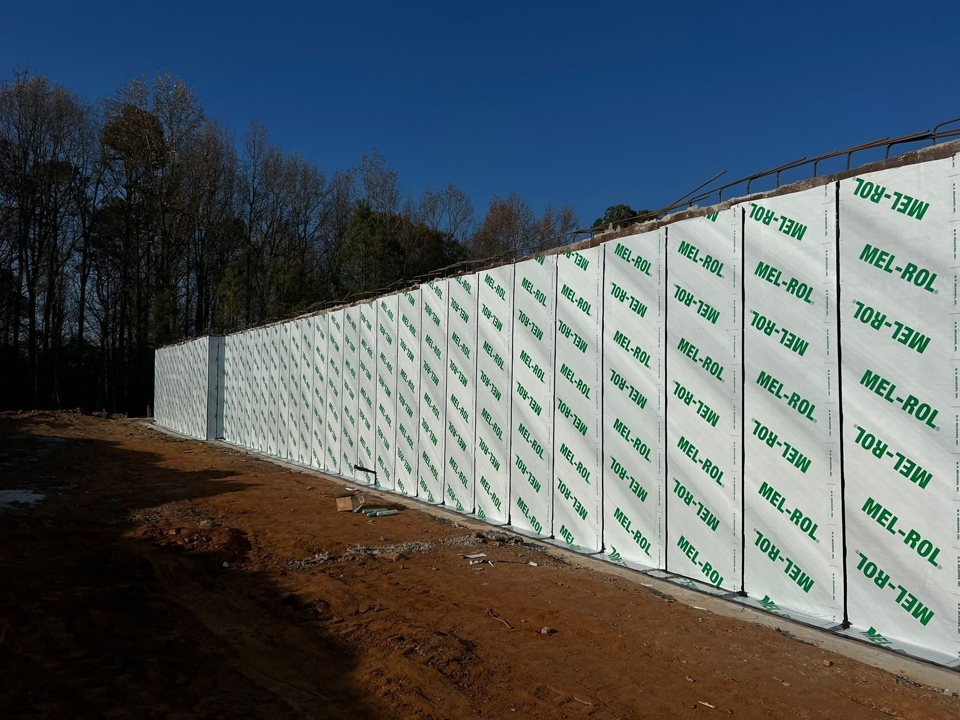 A large white wall with green letters that says ' mcl ' on it