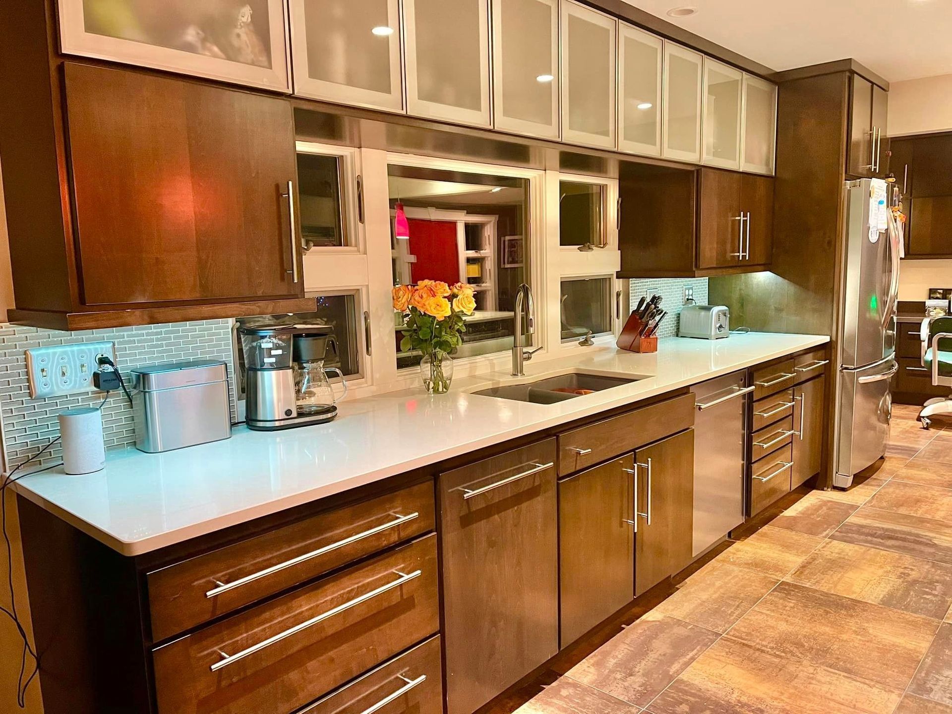 A kitchen with stainless steel appliances and wooden cabinets.