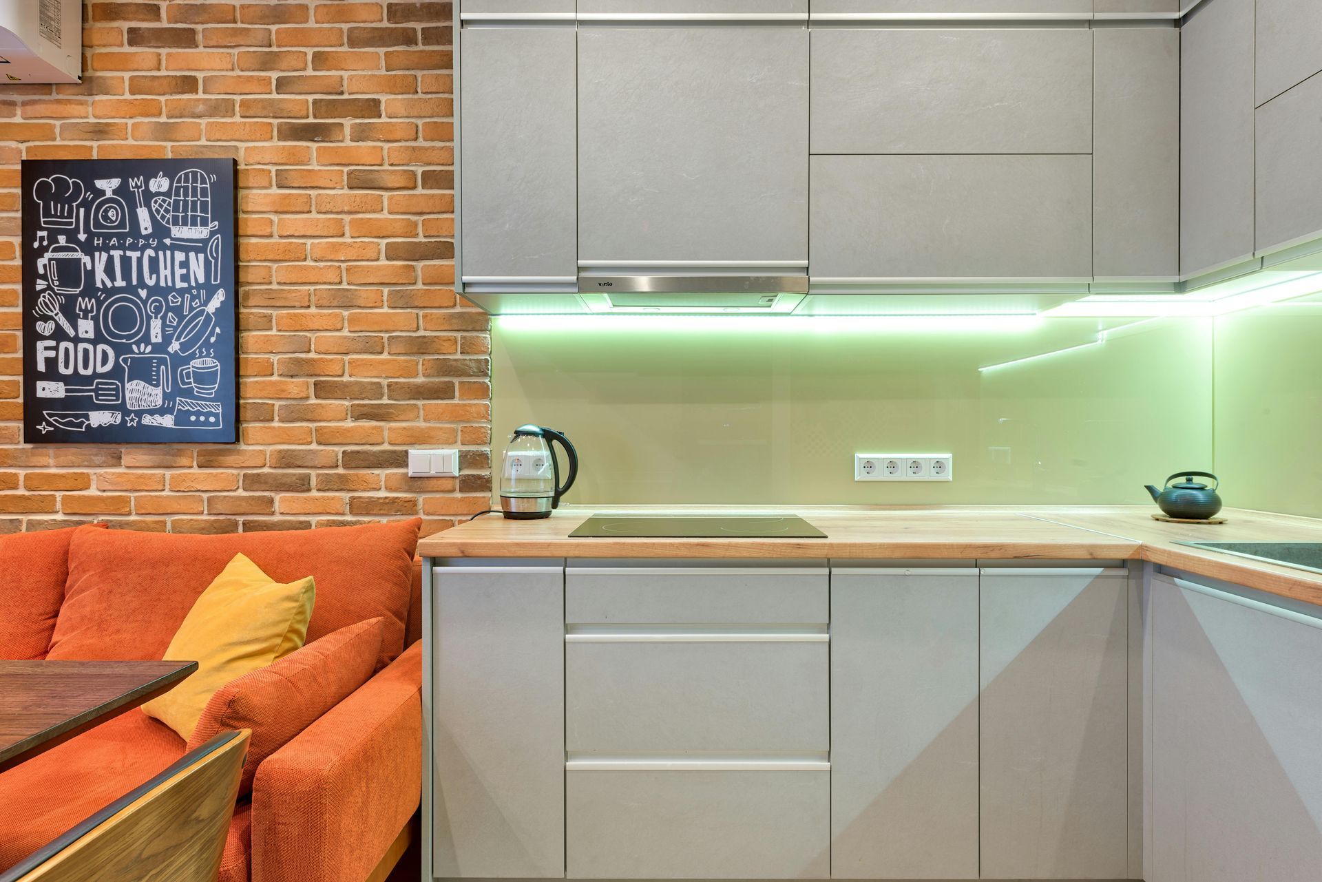 A kitchen with a couch and a sign on the wall that says `` kitchen ''.