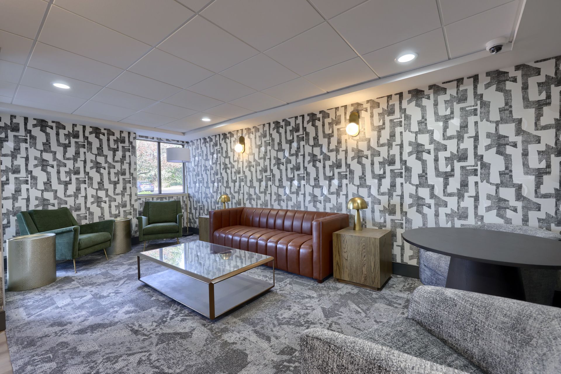 A living room with a couch , chairs , and a coffee table.