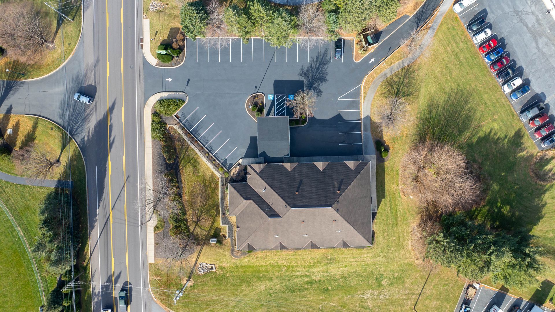 An aerial view of a building and a parking lot.