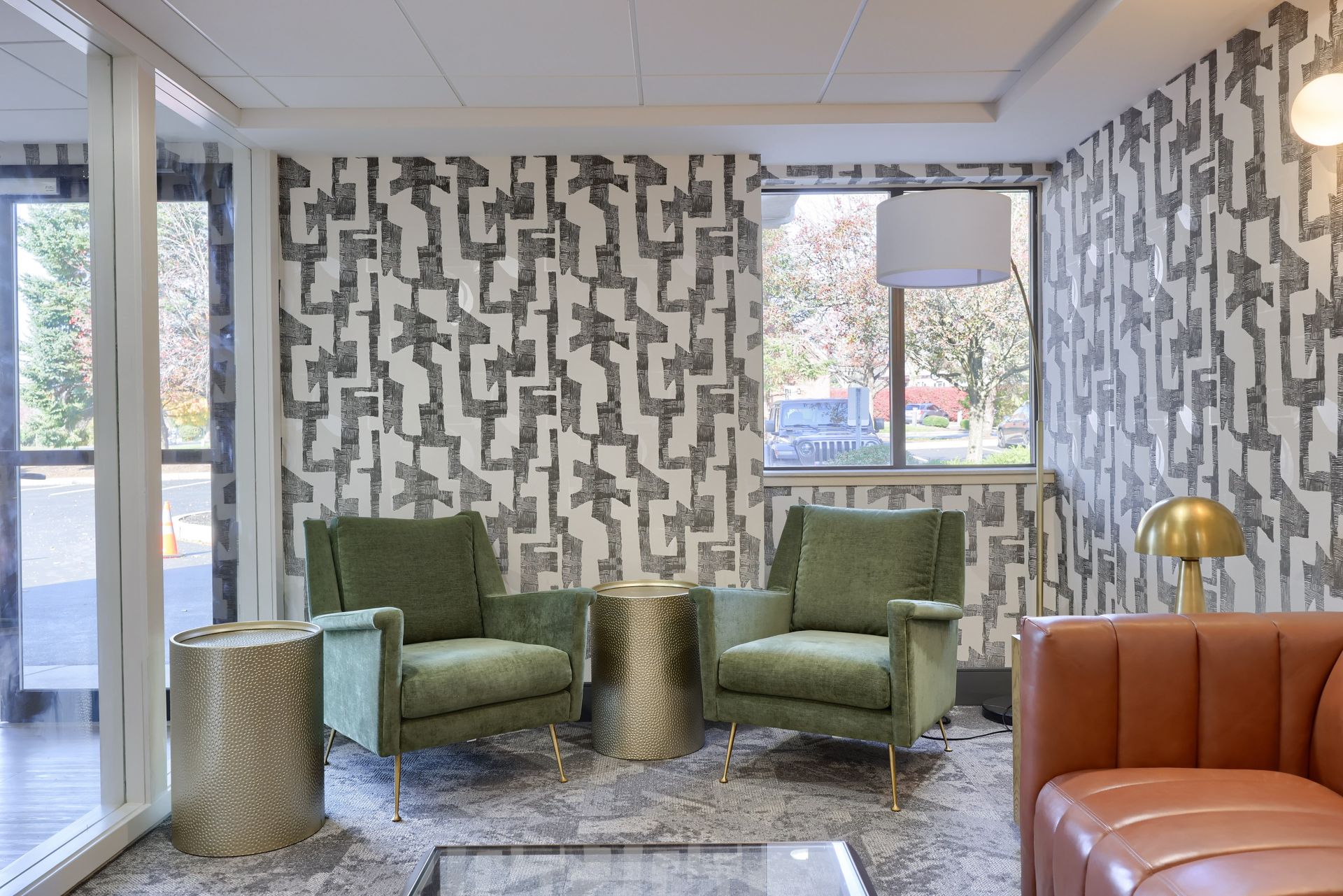 A living room with green chairs and a brown couch