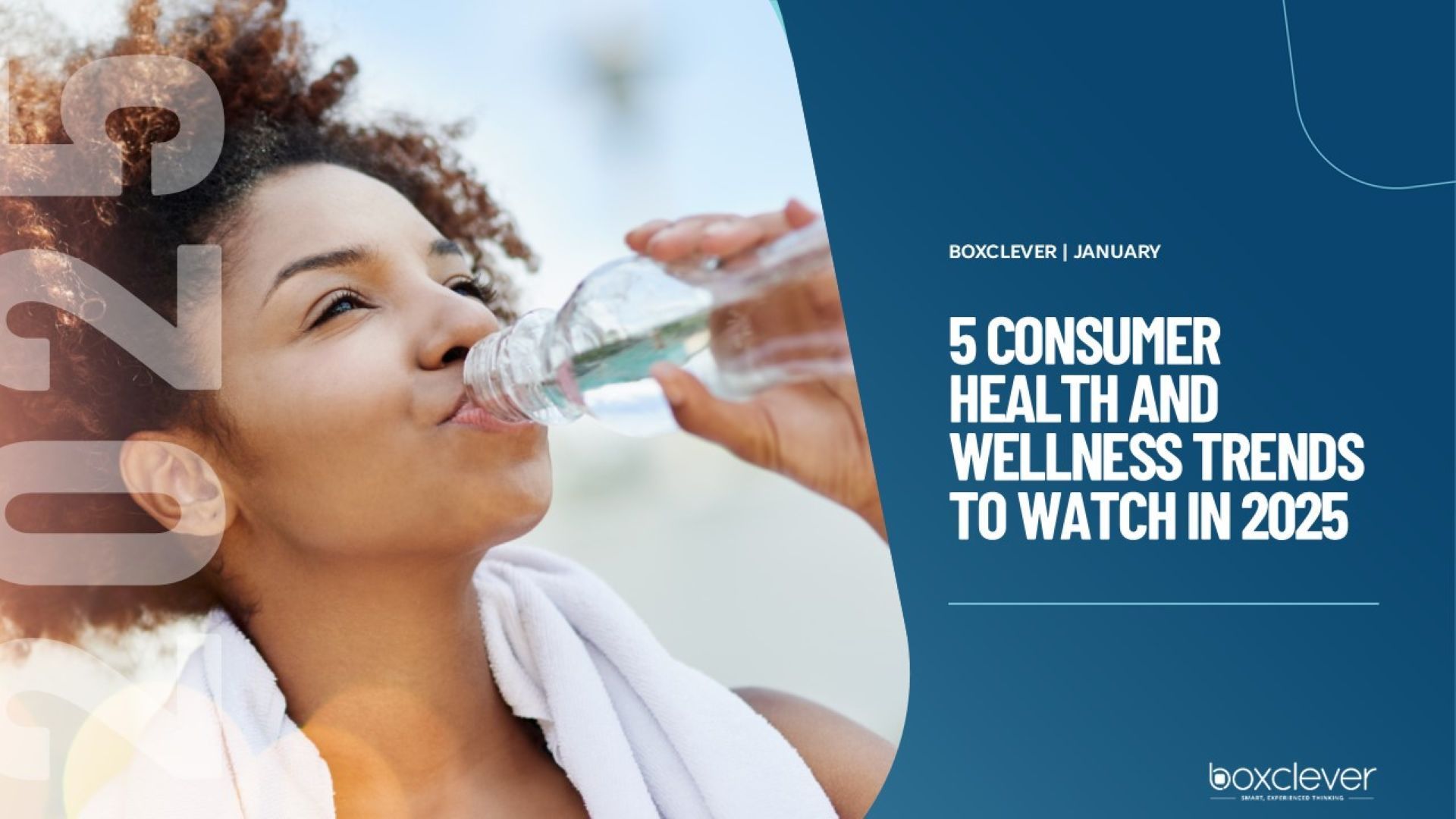 A woman is drinking water from a bottle.