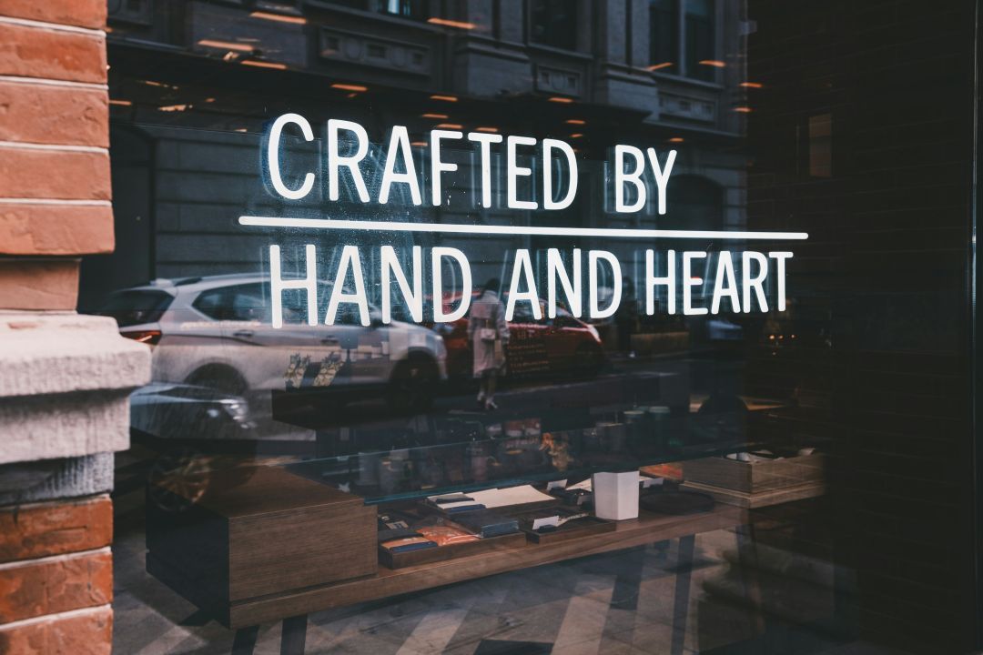 A window displays a sign for 'crafted by hand and heart'